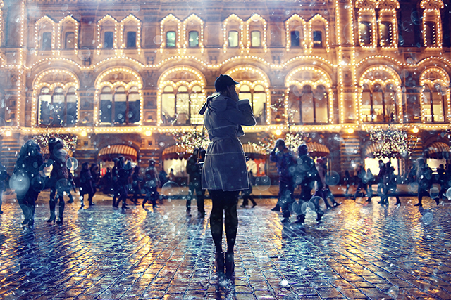 Lady standing watching shoppers